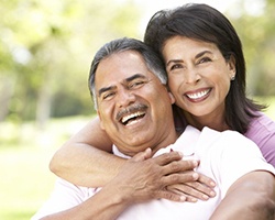 smiling couple with dental implants in Dallas, GA