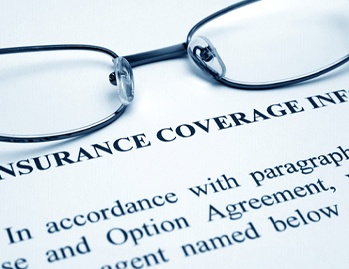 Dental insurance paperwork and glasses in Dallas