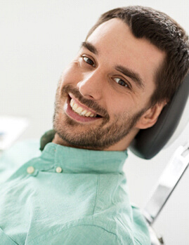 Dental patient smiling after use of DIAGNOdent technology