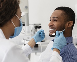 young man with dental implants in Dallas, GA visiting dentist 