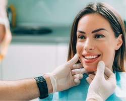 woman smiling while visiting dentist