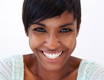 A middle-aged woman smiling wide and showing off her gummy smile in Dallas