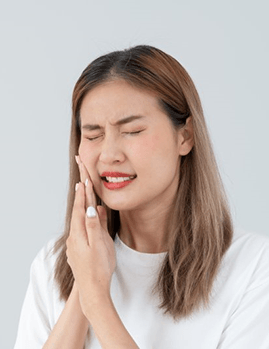 a man touching his jaw due to failed dental implant