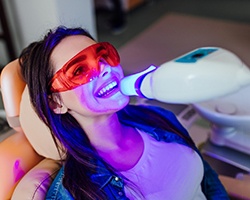 Woman receiving teeth whitening in Dallas