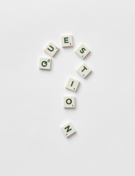 Question mark made from white Scrabble tiles