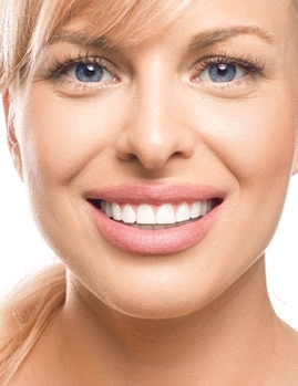 A young woman showing off her bright smile thanks to teeth whitening in Dallas
