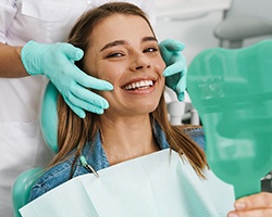 Woman with veneers in Dallas, GA smiling at dentist's office
