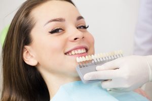 A woman having her tooth shade taken