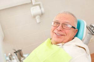 older man smiling green shirt