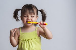 Young girl brushing her teeth