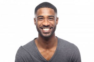 man smiling after seeing cosmetic dentist in Dallas 