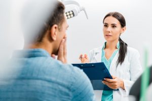 Dentist in Dallas speaking with patient