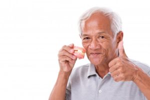 Man gives thumbs up for caring for dentures in Dallas, GA