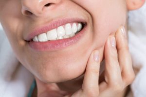 Woman with a toothache after teeth whitening