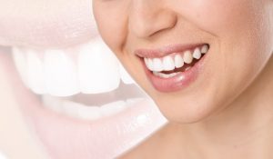 Woman with a beautiful smile using cosmetic dental treatments