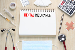 Notepad that says “Dental Insurance”, surrounded by medical equipment