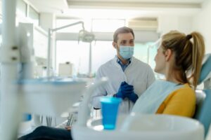 a dentist speaking with a patient about dental implants