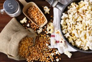 a setup of popcorn kernaes and salt