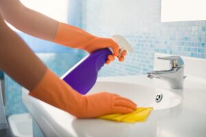 a person cleaning their bathroom