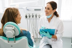 Dentist talking to patient.