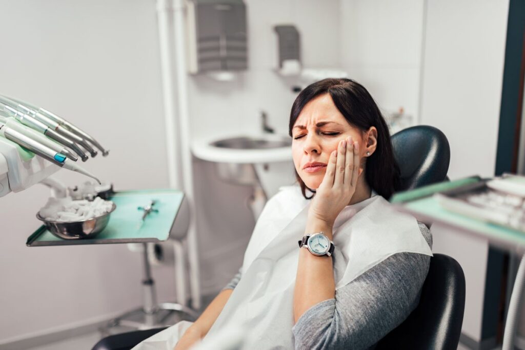 A woman at the dentist with a toothache