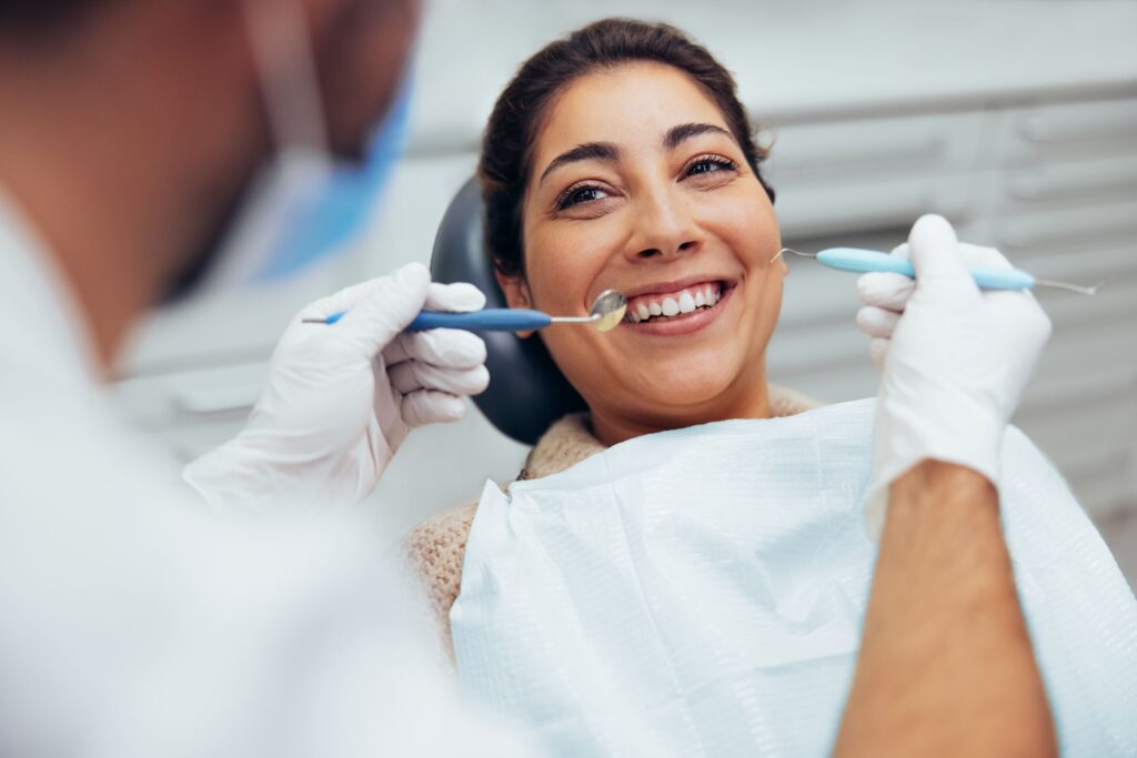 A woman smiling in a dental chair